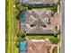 Aerial view of the home showing the private pool, screened lanai, and a well-manicured lot at 6318 Rivo Lakes Blvd, Sarasota, FL 34241