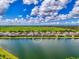 Scenic aerial view of a home with waterfront views, lush green lawn, and beautiful landscaping at 6318 Rivo Lakes Blvd, Sarasota, FL 34241