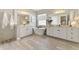 Elegant bathroom featuring double vanities, a freestanding tub, and modern finishes at 6318 Rivo Lakes Blvd, Sarasota, FL 34241