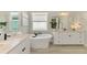 Bright bathroom featuring a soaking tub, dual sink vanity, and modern fixtures, creating a spa-like retreat at 6318 Rivo Lakes Blvd, Sarasota, FL 34241