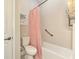 A functional bathroom featuring a toilet, shower with grab bar, and a neutral color scheme, providing comfort and safety at 6318 Rivo Lakes Blvd, Sarasota, FL 34241