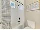 Bright bathroom showcasing a white tiled shower/tub, complemented by black hardware at 6318 Rivo Lakes Blvd, Sarasota, FL 34241