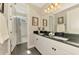 Stylish bathroom featuring a dual sink vanity with granite countertops and modern fixtures at 6318 Rivo Lakes Blvd, Sarasota, FL 34241