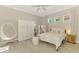 Bright bedroom features a hanging chair, large wardrobe, and neutral tones, offering a peaceful and stylish retreat at 6318 Rivo Lakes Blvd, Sarasota, FL 34241