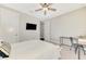 Cozy bedroom with mounted TV, desk area, and ceiling fan, offering a relaxing retreat at 6318 Rivo Lakes Blvd, Sarasota, FL 34241