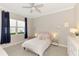 Charming bedroom featuring a plush bed, a window with natural light, and stylish decor, creating a warm and inviting space at 6318 Rivo Lakes Blvd, Sarasota, FL 34241