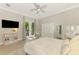 Bright bedroom features a hanging chair and double doors with outside views at 6318 Rivo Lakes Blvd, Sarasota, FL 34241