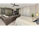 Spacious bonus room with a large leather sectional, entertainment setup, and barn door access at 6318 Rivo Lakes Blvd, Sarasota, FL 34241