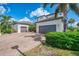 Spacious two-story home featuring a large driveway and two-car garage at 6318 Rivo Lakes Blvd, Sarasota, FL 34241