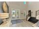 Bright foyer with double glass doors, staircase and decor at 6318 Rivo Lakes Blvd, Sarasota, FL 34241