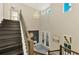Stunning two-story foyer with chandelier, dark wood staircase, and bright natural light at 6318 Rivo Lakes Blvd, Sarasota, FL 34241