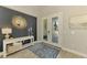 Welcoming foyer with statement mirror, console table and stylish rug at 6318 Rivo Lakes Blvd, Sarasota, FL 34241