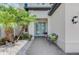 Inviting front entrance featuring double doors, a bench, and lush landscaping at 6318 Rivo Lakes Blvd, Sarasota, FL 34241