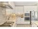 The modern kitchen features stainless appliances, gas cooktop and ample counter space at 6318 Rivo Lakes Blvd, Sarasota, FL 34241