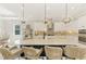 Kitchen boasts white cabinets, granite countertops, pendant lighting, and seating at the large island at 6318 Rivo Lakes Blvd, Sarasota, FL 34241