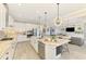 Spacious kitchen offers sleek stainless appliances, white cabinets and granite countertops open to the living area at 6318 Rivo Lakes Blvd, Sarasota, FL 34241