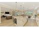Spacious kitchen with island seating overlooks the living and dining areas in an open floor plan at 6318 Rivo Lakes Blvd, Sarasota, FL 34241