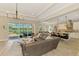 Open-concept living room, kitchen, with a view of the pool and lake at 6318 Rivo Lakes Blvd, Sarasota, FL 34241