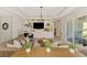 Open-concept living room featuring custom built-ins and access to outdoor living at 6318 Rivo Lakes Blvd, Sarasota, FL 34241