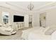 Relaxing main bedroom with neutral decor, a massage chair and a scenic outdoor view at 6318 Rivo Lakes Blvd, Sarasota, FL 34241