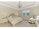 Bright main bedroom boasts a tray ceiling, wood-look tile floors, and a scenic water view at 6318 Rivo Lakes Blvd, Sarasota, FL 34241