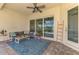 Covered patio featuring cozy seating, stylish decor, and views of the pool and lake at 6318 Rivo Lakes Blvd, Sarasota, FL 34241