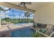 Beautiful screened-in pool area with comfortable seating and views of the lake at 6318 Rivo Lakes Blvd, Sarasota, FL 34241