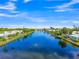 Aerial view of a waterfront community featuring a lake with fountain surrounded by houses at 655 Spanish Way, Longboat Key, FL 34228