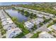 Aerial view of property backing up to a lake in a manicured community at 655 Spanish Way, Longboat Key, FL 34228