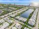 A scenic aerial view shows a coastal community with a pond, homes, and beach access at 655 Spanish Way, Longboat Key, FL 34228