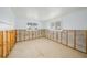 Unfinished basement showing concrete walls and floor with natural light coming from the windows at 655 Spanish Way, Longboat Key, FL 34228