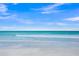 Serene beach scene featuring clear turquoise water, white sand, and gentle waves at 655 Spanish Way, Longboat Key, FL 34228