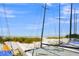 Picturesque beach scene with clear skies and rows of sailboats nestled along the shoreline at 655 Spanish Way, Longboat Key, FL 34228