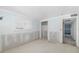 A bright bedroom undergoing renovation with fresh plaster and a glimpse into the closet at 655 Spanish Way, Longboat Key, FL 34228