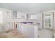 Partially renovated kitchen with white cabinetry, and updated drywall at 655 Spanish Way, Longboat Key, FL 34228