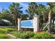 Welcome To Longboat Key sign surrounded by lush tropical landscaping at 655 Spanish Way, Longboat Key, FL 34228