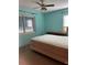 Simple bedroom featuring a modest bed, dresser, and a window for natural light at 6803 Washington Pl, Bradenton, FL 34207
