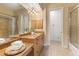 Bathroom with a tiled floor, granite countertop vanity, mirror, lighting, and a glass shower at 7144 Ashland Gln, Lakewood Ranch, FL 34202