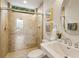 Bathroom features a tiled walk-in shower, a modern sink, and decorative accents at 7144 Ashland Gln, Lakewood Ranch, FL 34202