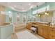 Bright bathroom featuring double vanity, bathtub, tiled floor, stylish lighting, and ample counter space at 7144 Ashland Gln, Lakewood Ranch, FL 34202