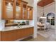 Chic dining space next to a bar with granite counters, leading to a cozy living room and sunlit entryway at 7144 Ashland Gln, Lakewood Ranch, FL 34202