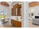 Elegant dining room featuring a charming chandelier and built-in cabinets with granite countertops at 7144 Ashland Gln, Lakewood Ranch, FL 34202
