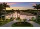 Elegant home with lush landscaping, circular driveway, and access to golf course views at 7144 Ashland Gln, Lakewood Ranch, FL 34202
