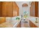Well-appointed kitchen featuring wood cabinets, granite countertops, and an adjacent dining area with a sun-filled view at 7144 Ashland Gln, Lakewood Ranch, FL 34202