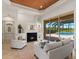 Inviting living room featuring a modern fireplace, upscale decor, and serene pool view through sliding glass doors at 7144 Ashland Gln, Lakewood Ranch, FL 34202