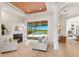 Comfortable living room with a fireplace, stylish furnishings, and views of the inviting pool and backyard at 7144 Ashland Gln, Lakewood Ranch, FL 34202