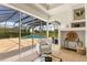 Living room featuring sliding glass doors that open to an outdoor entertaining area with a pool at 7144 Ashland Gln, Lakewood Ranch, FL 34202