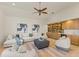 Spacious living room features built-in shelves, a white sofa, and views of the backyard at 7144 Ashland Gln, Lakewood Ranch, FL 34202
