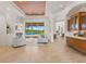 Bright living room featuring elegant decor, a cozy fireplace, and a view of the sparkling pool area at 7144 Ashland Gln, Lakewood Ranch, FL 34202