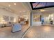 Open-concept living room with sliding glass doors leading to a covered outdoor area and kitchen views at 7144 Ashland Gln, Lakewood Ranch, FL 34202